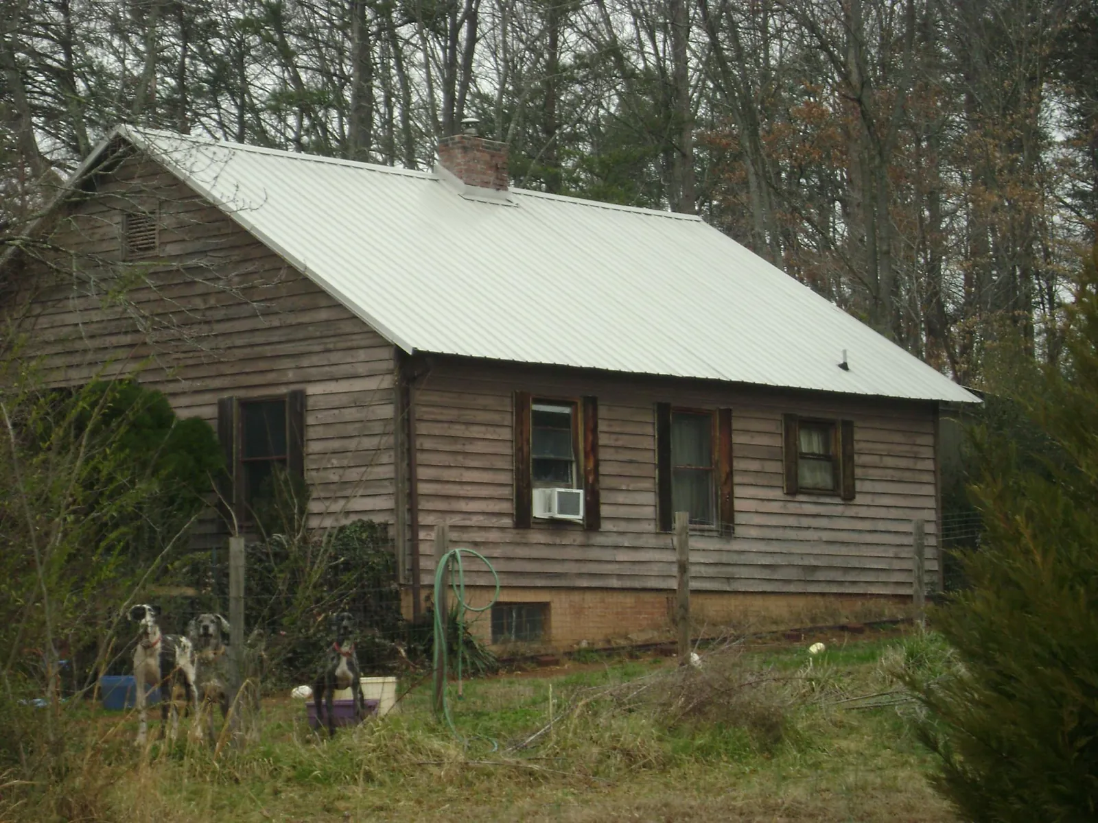 White metal roof on an old wood sided farmhouse, from a Metal Roof Installation job in Furman